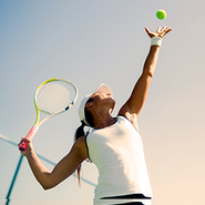 A woman prepares to hit a tennis ball.