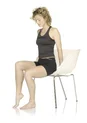 A woman performs targeted movement exercises.