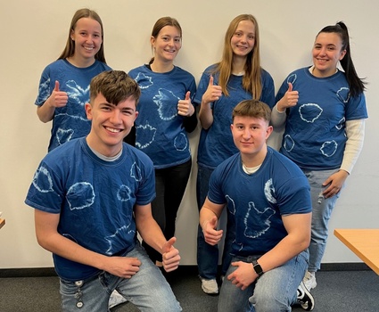 6 Azubis tragen ihre selbst gebatikten T-Shirts in Blau und Weiß.