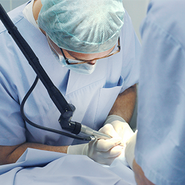 A doctor performs surgery on a patient.